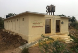 FILE - A public toilet built as part of the "Clean India" mission, is pictured in Guladahalli village in the southern state of Karnataka, India, April 30, 2019.