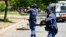 FILE - South African policemen fire rubber bullets at protesters in Mothotlung, Jan. 14, 2014.