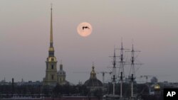 FILE - A bird is silhouetted against full moon in St. Petersburg, Russia, March 29, 2021. Russia on Saturday ordered the expulsion of Ukraine's consul in St. Peterburg for allegedly trying to obtain classified information.