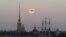FILE - A bird is silhouetted against full moon in St. Petersburg, Russia, March 29, 2021. Russia on Saturday ordered the expulsion of Ukraine's consul in St. Peterburg for allegedly trying to obtain classified information.