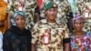 Major General Kenneth Chigbu, deputy theatre commander of Operation Hadin Kai is shown with poses for a group photograph with Alice Loksha, left, and Fayina Ali at Army Barrack Maimalari Cantonment in Maiduguri, Nigeria, on November 15, 2024.