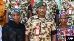 Major General Kenneth Chigbu, deputy theatre commander of Operation Hadin Kai is shown with poses for a group photograph with Alice Loksha, left, and Fayina Ali at Army Barrack Maimalari Cantonment in Maiduguri, Nigeria, on November 15, 2024.