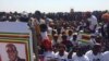 Zanu PF carrying a banner with a picture of President Robert Mugabe.