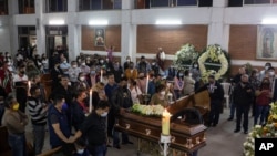 Relatives, friends and journalists stand beside the coffin of slain Mexican radio journalist Jacinto Romero Flores, during a Mass in Ixtaczoquitlan, Veracruz state, Mexico, Aug. 19, 2021. 