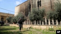 Iraqi federal police stand guard outside Mosul's heavily damaged museum, March 8, 2017. The facility was retaken from Islamic State forces on March 7.