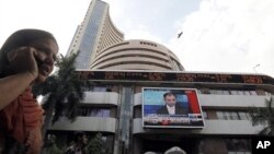 A woman speaks on her phone as she walks past the Bombay Stock Exchange (BSE) building in Mumbai (File Photo)