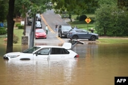 A car is stranded on a flooded street after Hurricane Helene made landfall in Atlanta, Georgia, on Sept. 27, 2024.