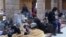 A still image taken from a video, said to have been shot Jan. 4, 2017, shows civilians, who were evacuated from Wadi Barada, sitting inside a shelter in the Damascus suburb of Rawda, Syria.
