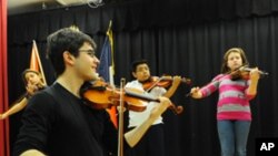 Nathan Schram works with his students at P.S. 75, an elementary school in Brooklyn, New York.