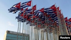 Cuban flags fly beside the United States Interests Section in Havana (USINT), Dec. 30, 2014.