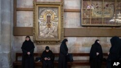 FILE—Christian Orthodox pilgrims attend the Palm Sunday procession at the Church of the Holy Sepulchre, in the Old City of Jerusalem, March 24, 2024.