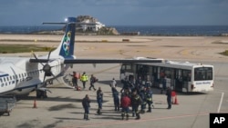 Fire service rescuers arrive at the airport of the earthquake-hit island of Santorini, Greece, Feb. 5, 2025.