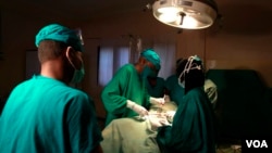 FILE - Doctors are seen operating on a cancer patient in a hospital. (Photo - Rael Ombuor/VOA)