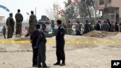 Security forces inspect the site of a suicide attack on prison employees' vehicle in Kabul, Afghanistan, Oct. 31, 2018. 