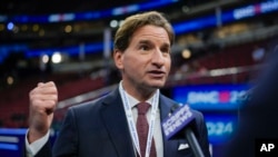 FILE - Representative Dean Phillips talks on the floor before the Democratic National Convention in Chicago, Aug. 19, 2024.