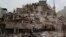 Workers shovel papers and debris off the top of the rubble of a building that collapsed in last week's 7.1 magnitude earthquake, at the corner of Gabriel Mancera and Escocia streets in the Del Valle neighborhood of Mexico City, Monday, Sept. 25, 2017. 