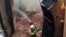 A firefighter puts out a fire at the Cavallerizza Reale, royal stables part of a UNESCO World Heritage site in the center of Turin, Oct. 21, 2019.