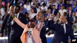 FILE - The Central Park Five join Reverend Al Sharpton during the Democratic National Convention, Aug. 22, 2024, in Chicago.