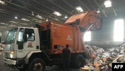 Trucks deliver trash and recycling waste at the District of Columbia’s Fort Totten Transfer Station in Washington, DC, on July 10, 2018. (AFP Photo)