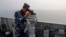 Chinese naval sailor monitors sea conditions on board Chinese frigate Linyi during multi-country maritime joint exercises off the coast in Qingdao, Shandong province, April 23, 2014.