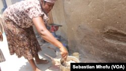 FILE: A women prepares food for children.