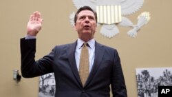 FILE - FBI Director James Comey is sworn in on Capitol Hill in Washington, July 7, 2016, prior to testifying before the House House Oversight and Government Reform Committee hearing to explain his agency's recommendation to not prosecute Democratic presidential candidate Hillary Clinton over her private email setup.
