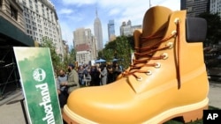 FILE - Timberland drops a 13-foot replica of its iconic wheat boot at a pop-up park in New York City, Oct. 16, 2018.