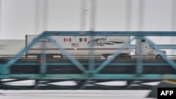 FILE - A truck crosses the Ambassador Bridge from Windsor, Ontario, to Detroit, Michigan, on Jan. 31, 2025.