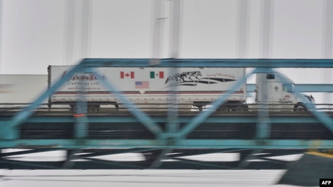 FILE - A truck crosses the Ambassador Bridge from Windsor, Ontario, to Detroit, Michigan, on Jan. 31, 2025.