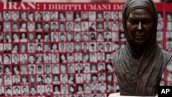 Bust of Neda Agha Soltan, a student killed during Tehran's 2009 election protests, before pictures of what rights advocates say are victims of Iranian human rights violators, Rome, Feb. 11, 2010.
