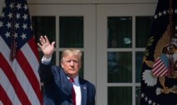 US President Donald Trump waves after signing HR 1327, an act to permanently authorize the September 11th victim compensation fund, during a ceremony in the Rose Garden of the White House in Washington, DC, July 29, 2019.