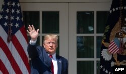 US President Donald Trump waves after signing HR 1327, an act to permanently authorize the September 11th victim compensation fund, during a ceremony in the Rose Garden of the White House in Washington, DC, July 29, 2019.