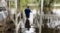 Shawn Lowrimore, Pastor Willie Lowrimore of The Fellowship With Jesus Ministries', son, wades into water near the church in Yauhannah, S.C., on Sept. 24, 2018. 