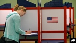 FILE - Kate Irish votes at the Durham County North Regional Library in Durham, N.C., May 8, 2018. Federal authorities will analyze laptops that malfunctioned in the county during the 2016 election.