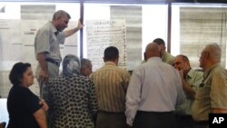 Participants in a regional conference for instituting public meetings into the provincial development process in Iraq. 