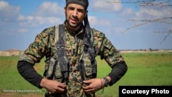 FILE - William Savage poses during a training session with the Kurdish People’s Protection Units (YPG) in Syria. (Photo courtesy of the YPG Media Center)