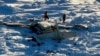 This photo provided by the US Coast Guard on Feb. 7, 2025, shows a small commuter plane that crashed in western Alaska on a flight that was bound for the hub community of Nome. 