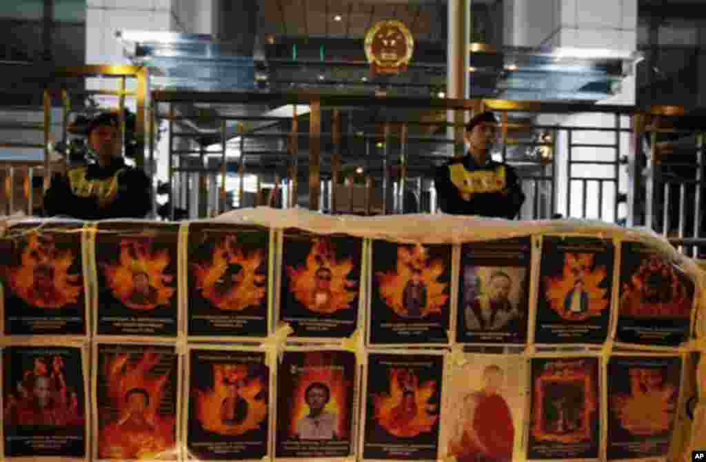 Protesters display the pictures of the Tibetans believed to have committed self-immolation in Tibet during a candlelight vigil outside the China Liaison Office in Hong Kong Wednesday, Feb. 22, 2012.