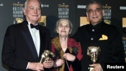 (L-R) James Ivory, Ruth Prawer Jhabvala and Ismail Merchant, who together form Merchant Ivory Productions, receive a British Academy film fellowship at a ceremony in central London, Feb. 24, 2002. 