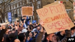 Football supporters demonstrate against the proposed European Super League outside of Stamford Bridge football stadium in London, April 20, 2021.