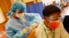 FILE - A man receives a COVID vaccine at a vaccination site, in Naypyitaw, Myanmar, Jan. 29, 2021, just days before a military coup threw the country into turmoil.