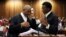 Advocate Dali Mpofu (L) reacts as he chats to Advocate Tembeka Ngcukaitobi during court hearing arguments on a report into allegations of political interference by wealthy friends of President Jacob Zuma, at the North Gauteng High Court, in Pretoria, South Africa. November 2, 2016. 