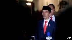 Indonesian President Joko Widodo speaks to the media upon arrival from his inauguration for his second term, at Merdeka Palace in Jakarta, Indonesia, Oct. 20, 2019.