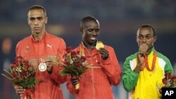 Gold medallist Samuel Kamau Wanjiru of Kenya (C), silver medallist Jaouad Gharib of Morocco (L) and bronze medallist Tsegay Kebede of Ethiopia pose for victory ceremony at the Beijing 2008 Olympic Games (File Photo - August 24, 2008)