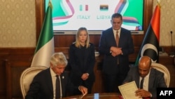 FILE—Italy's Sports Minister Andrea Abodi (L) and his counterpart from Libya Abdulshfie Hussien Al-Jwifi sign an agreement as Libya's interim Prime Minister Abdulhamid Dbeibah (C-R) and Italy's Prime Minister Giorgia Meloni (C-L) look on in Tripoli on May 7, 2024.