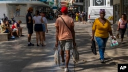 ARCHIVO - Un hombre transporta pescado recién pescado por La Habana, Cuba, el 6 de diciembre de 2025.