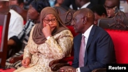 Tanzania's President Samia Suluhu Hassan talks with her Kenyan counterpart William Ruto as they attend the Africa Energy Summit in Dar es Salaam, Tanzania, Jan. 28, 2025.