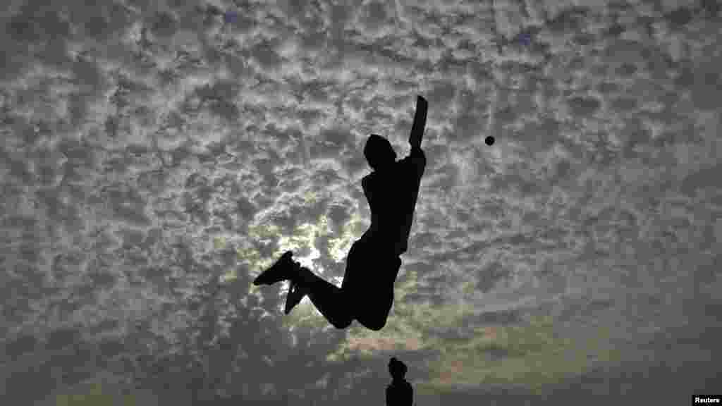 Boys play cricket on the Marina beach in the southern Indian city of Chennai.