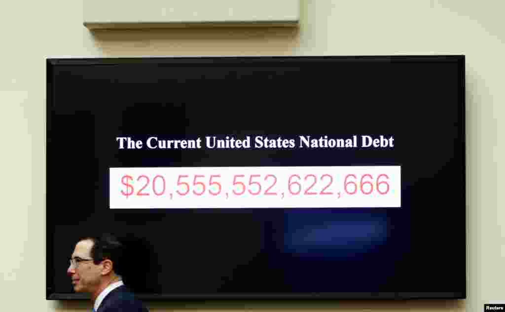 Treasury Secretary Steven Mnuchin walks past a display of the U.S. national debt as he testifies to the House Financial Services Committee on &quot;The Annual Report of the Financial Stability Oversight Council,&quot; on Capitol Hill in Washington.
