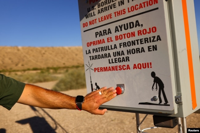 U.S. Border Patrol Agent Fidel Baca shows a "rescue beacon," placed by U.S. Customs and Border Protection in remote areas where migrants can press a red button to request help. This one is near Sunland Park, New Mexico, Oct. 5, 2023.